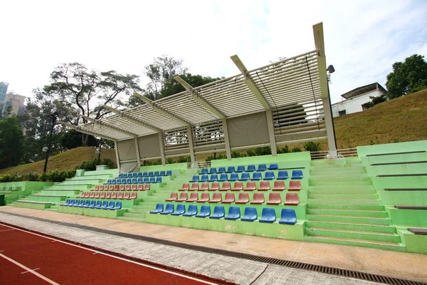 Stadium chairs and running track — Stock Photo, Image