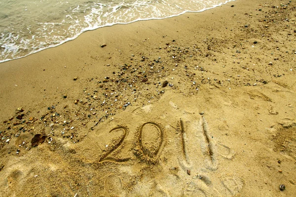 2011 op zand — Stockfoto