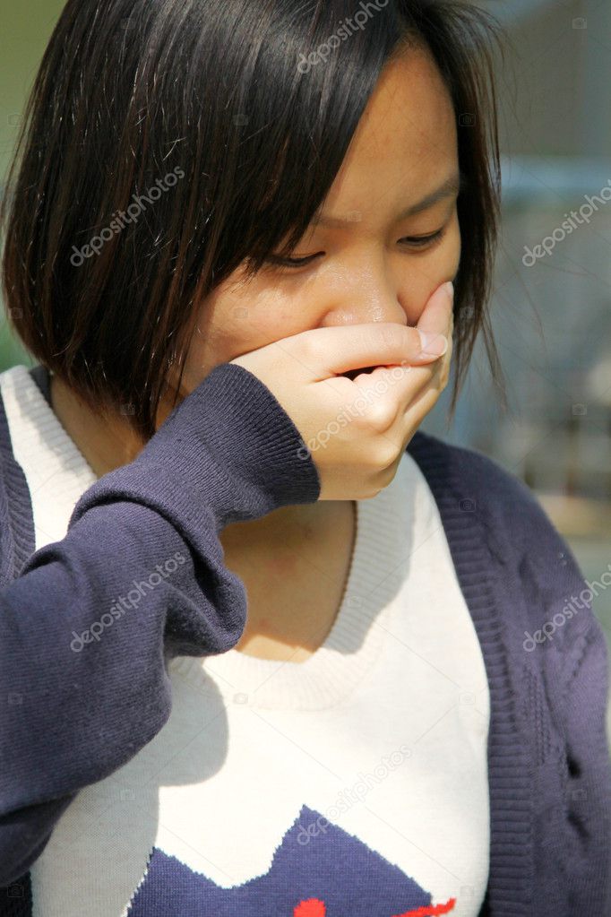 Asian woman sneezing