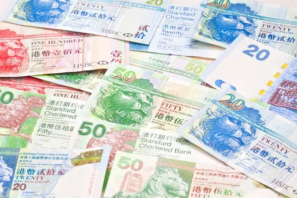 Hong Kong currency with different dollars background — Stock Photo, Image