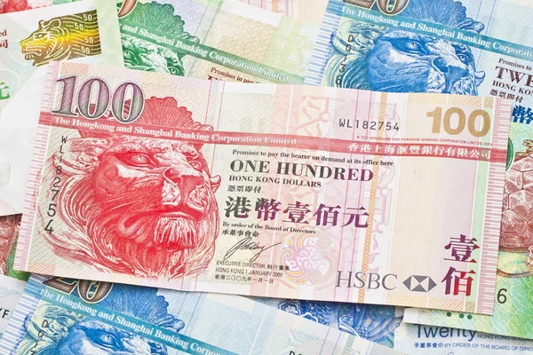 Moeda de Hong Kong com diferentes dólares de fundo — Fotografia de Stock