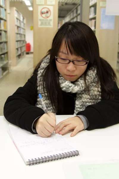 Ázsiai egyetemista a könyvtárban — Stock Fotó