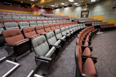 Lecture hall with colorful chairs in a university clipart