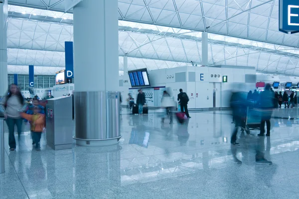 Moving in airport in blue toned — Stock Photo, Image