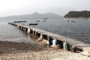 Wooden pier along the coast clipart