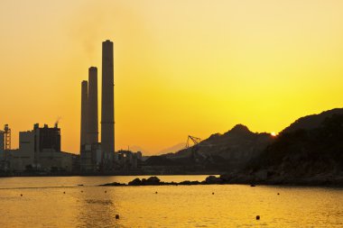 Power station along coast at sunset in Hong Kong