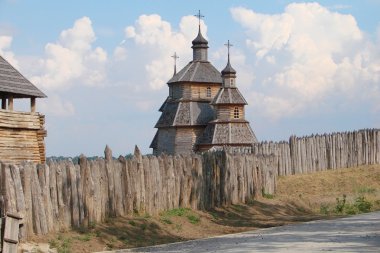 Wooden stockade and a church clipart