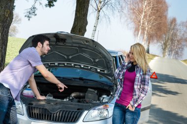 Car breakdown couple calling for road assistance clipart