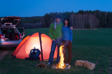 Tent camping car couple stand by bonfire clipart