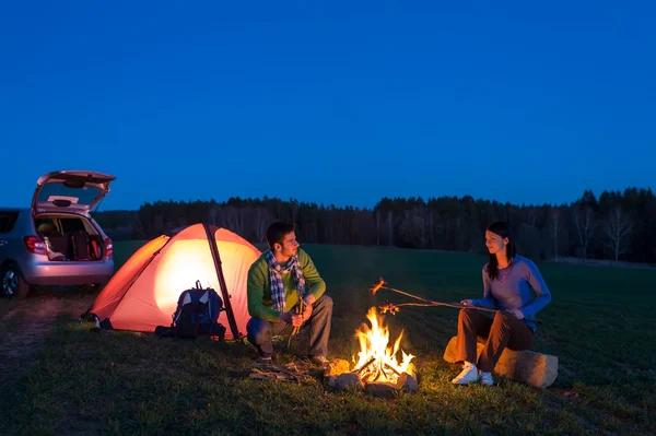 たき火のそばに座って車のカップルのキャンプ テント — ストック写真