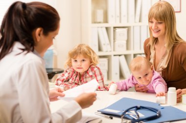 Mother with children at the pediatrician office clipart