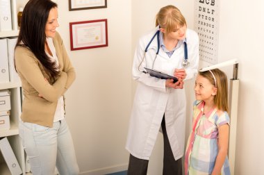 Medical check-up at pediatrist girl measure height clipart