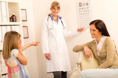 Girl reading eye chart pediatrician office clipart