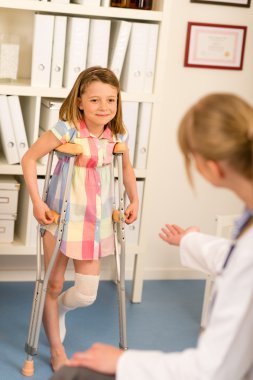 At the pediatrician little girl with crutches clipart