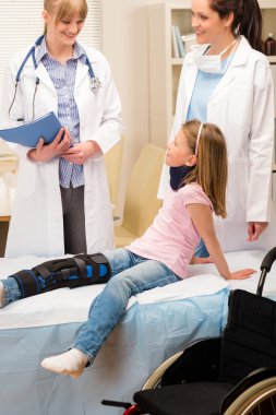 Pediatrician examining girl broken leg clipart