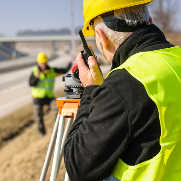 Geodesist measure land with tacheometer highway — Stock Photo, Image