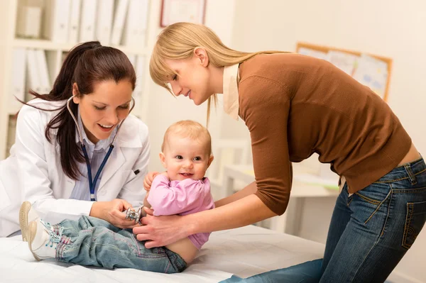 Pediatrician examine baby with stethoscope Royalty Free Stock Images