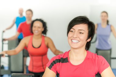 Smiling woman at fitness class gym workout clipart