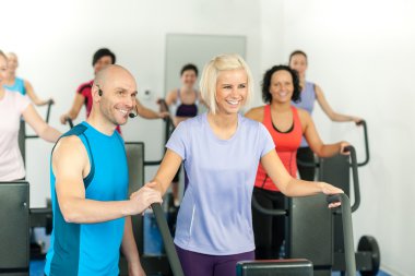 Fitness instructor leading gym exercise clipart