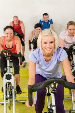 Young woman at spinning class enjoy workout clipart