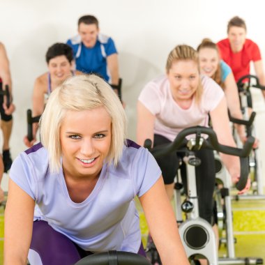 Fitness young woman on gym bike spinning