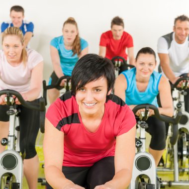 Fitness group of on gym bike clipart