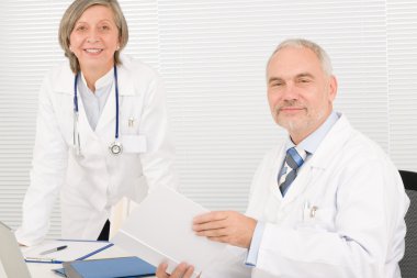 Medical team senior doctor with work colleague clipart