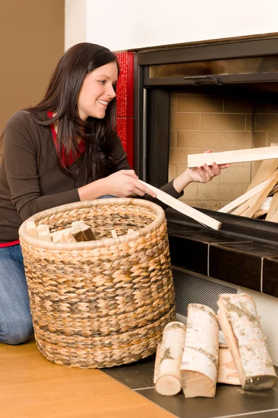 Home fireplace woman put logs happy winter — Stock Photo, Image