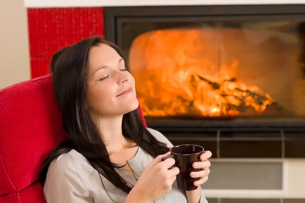 Winter home fireplace woman drink closed eyes — Stock Photo, Image
