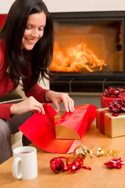 Christmas wrap present happy woman home fireplace — Stock Photo, Image