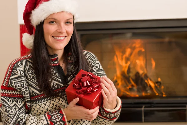 Christmas present woman Santa hat home fireplace — Stock Photo, Image