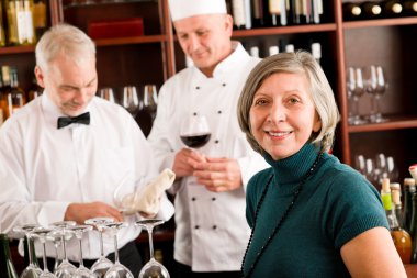 Restaurant manager with staff at wine bar clipart