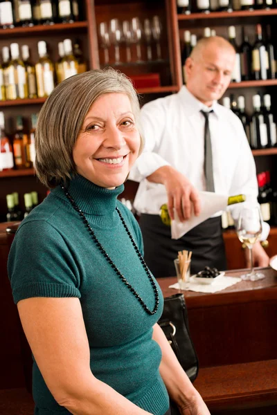 葡萄酒吧高级女人享受葡萄酒杯 免版税图库照片