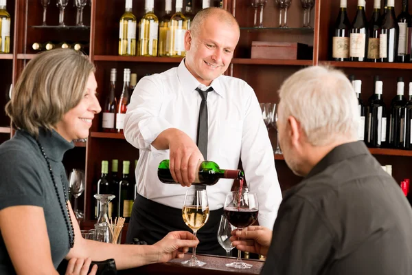 Wine bar senior couple barman pour glass Royalty Free Stock Images