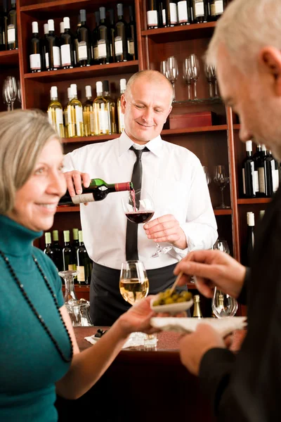 Wine bar senior couple barman pour glass Stock Image