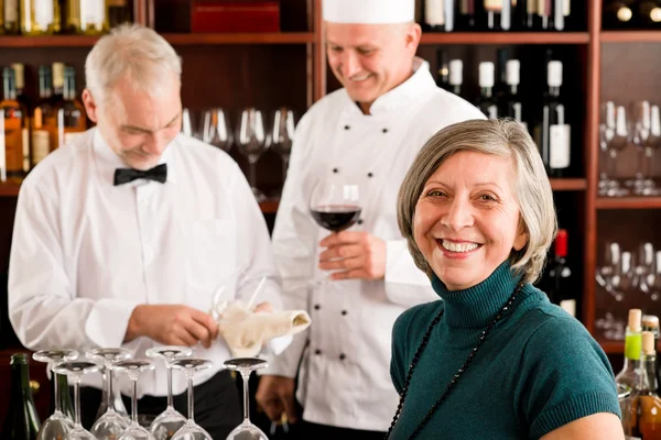 Restaurant manager with staff at wine bar Stock Photo