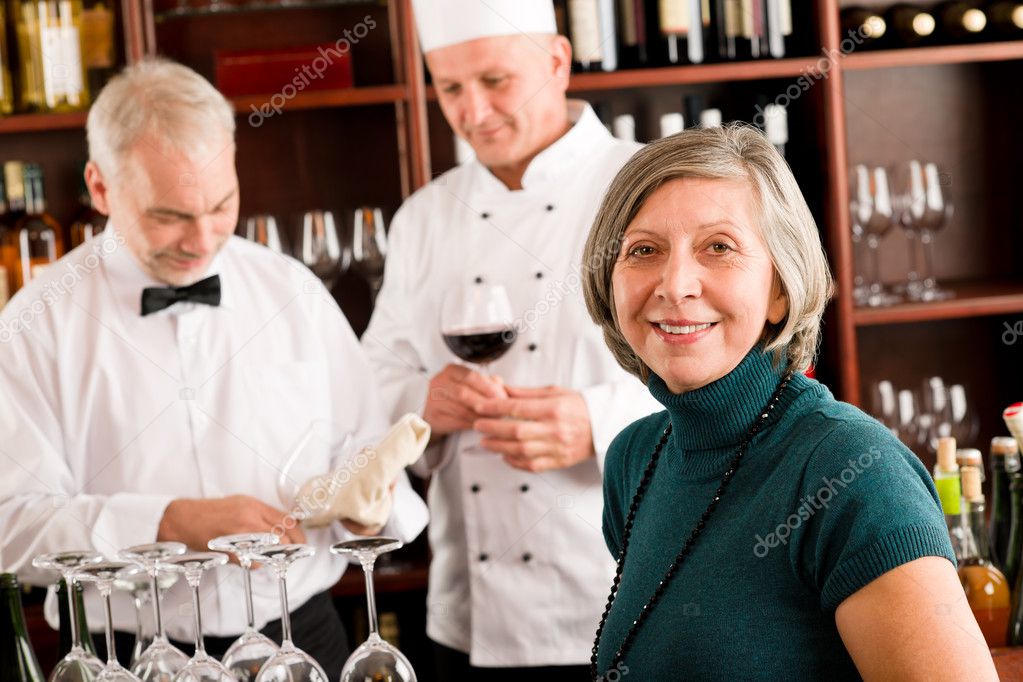 Restaurant manager with staff at wine bar