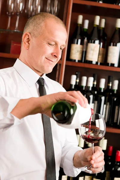 Wine bar waiter pour glass in restaurant Stock Photo