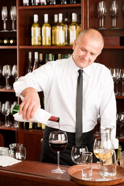 Wine bar waiter pour glass in restaurant Royalty Free Stock Images