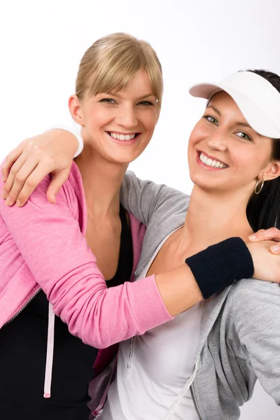 Two sport woman friends hugging smiling — Stock Photo, Image