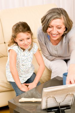 Grandmother teach young girl learn music notes clipart