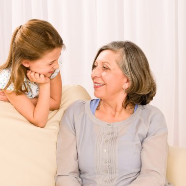 Grandmother and granddaughter look at each other clipart