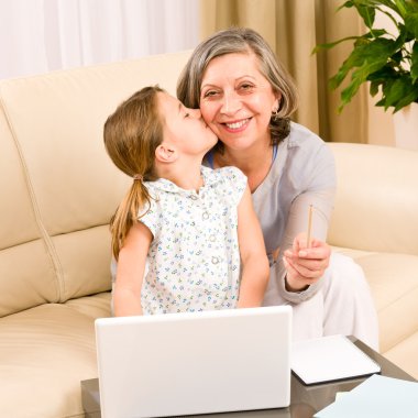 Granddaughter giving kiss to grandmother smiling clipart