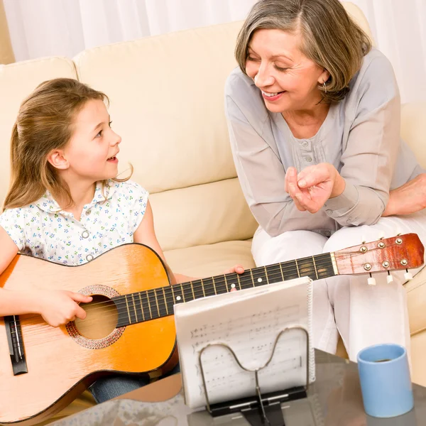 年轻的女孩唱歌玩吉他的祖母 — 图库照片