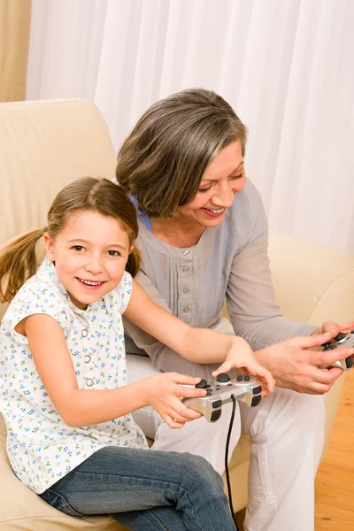 Grandmother and granddaughter play computer game — Stock Photo, Image