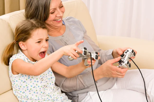 Grandmother and granddaughter play computer game — Stock Photo, Image