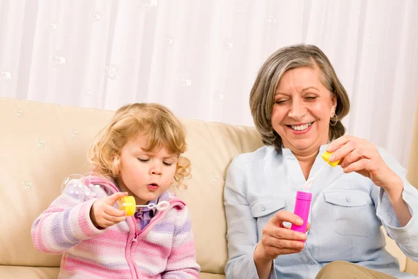 Κοριτσάκι με την γιαγιά παιχνίδι φούσκα φυσητήρας — Φωτογραφία Αρχείου