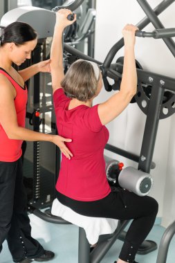 Fitness center trainer senior woman exercise back clipart