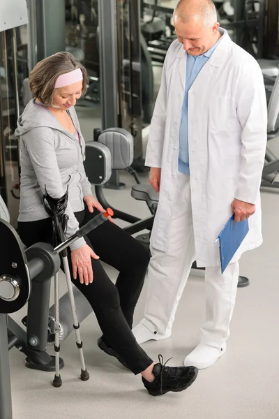 Senior woman with help of physiotherapist — Stock Photo, Image