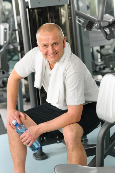 Active man relax sitting by fitness machine — Stock Photo, Image